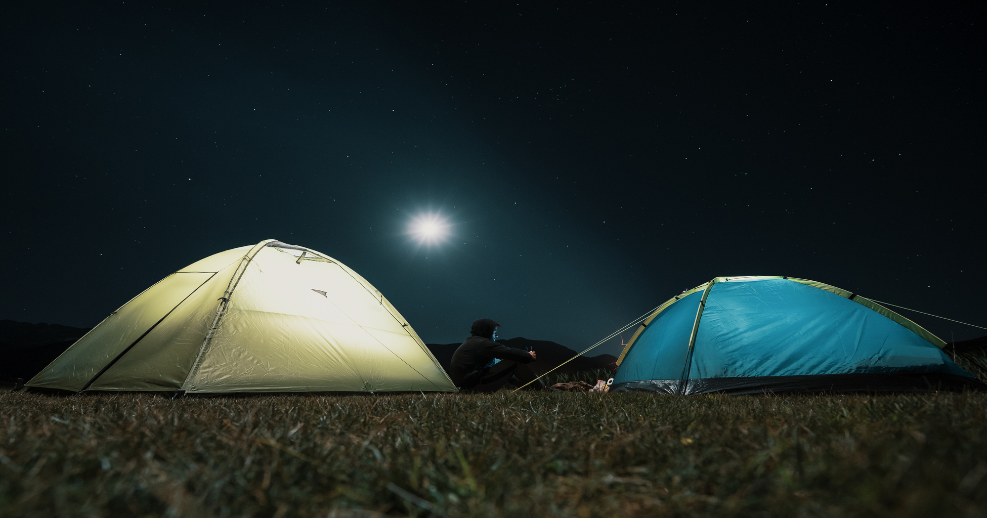 tourist-tents-in-camp-among-meadow-in-the-night-mountains