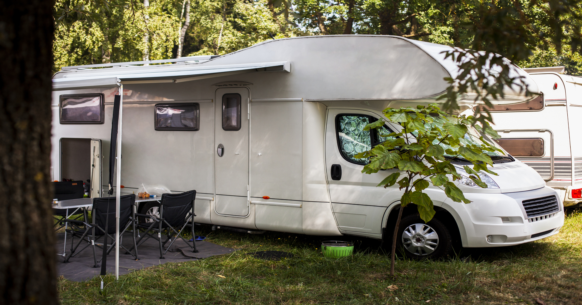 white-van-with-table-and-chairs-next-to-it